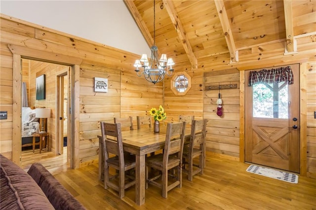 105 Ranch Mountain Ct, Dahlonega, GA 30533 - dining area with wooden ceiling, a chandelier, wood walls, and light wood-style flooring
