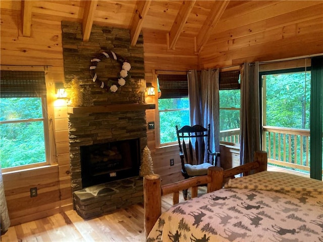 105 Ranch Mountain Ct, Dahlonega, GA 30533 - bedroom featuring wooden walls, wooden ceiling, wood finished floors, and a stone fireplace