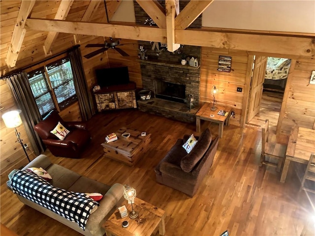 105 Ranch Mountain Ct, Dahlonega, GA 30533 - living area with wood finished floors, wooden walls, a ceiling fan, and a fireplace