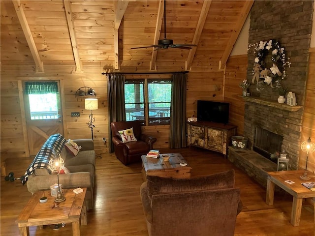 105 Ranch Mountain Ct, Dahlonega, GA 30533 - living area featuring wood ceiling, wood finished floors, ceiling fan, wooden walls, and a stone fireplace