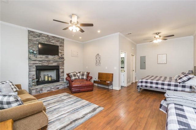 105 Ranch Mountain Ct, Dahlonega, GA 30533 - living area featuring ceiling fan, electric panel, wood finished floors, a stone fireplace, and crown molding