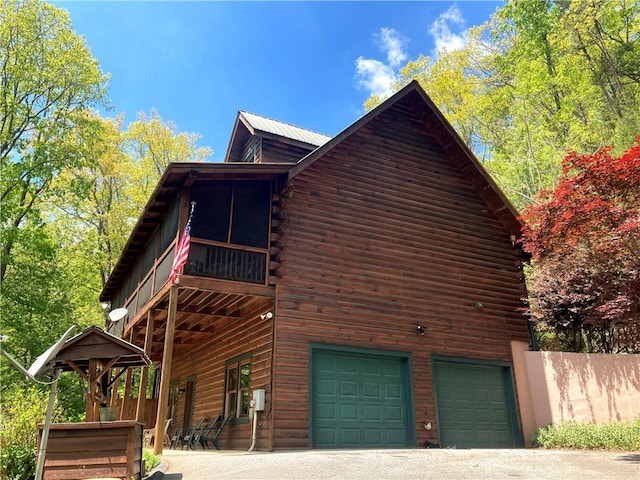 105 Ranch Mountain Ct, Dahlonega, GA 30533 - view of property exterior featuring a garage, log exterior, driveway, and metal roof