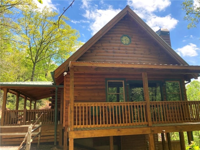 105 Ranch Mountain Ct, Dahlonega, GA 30533 - view of side of property featuring a chimney and a wooden deck