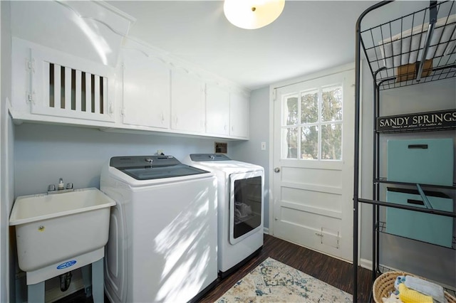 laundry area with separate washer and dryer, dark wood-type flooring, a sink, and cabinet space