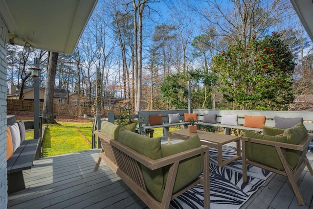 deck featuring a lawn, outdoor lounge area, and fence