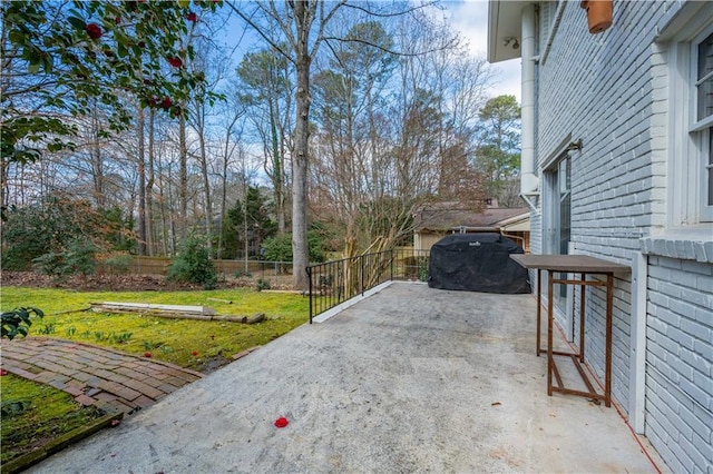 view of patio featuring fence