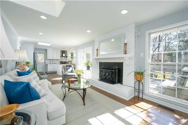 living room with a skylight, plenty of natural light, and visible vents