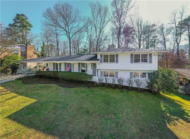 split level home featuring an attached carport and a front lawn