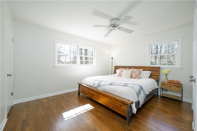 bedroom featuring wood finished floors, a ceiling fan, and baseboards