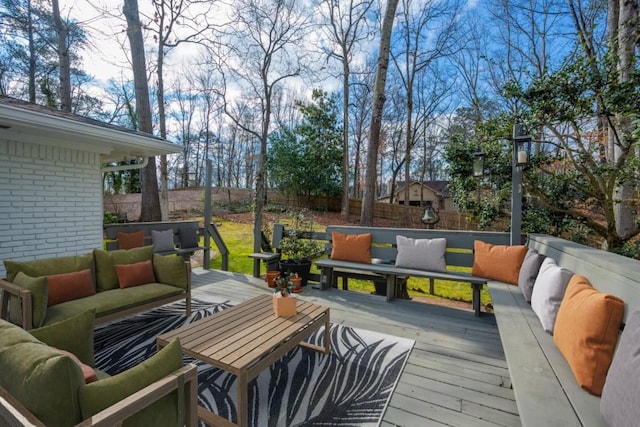 wooden terrace with a fenced backyard and an outdoor hangout area