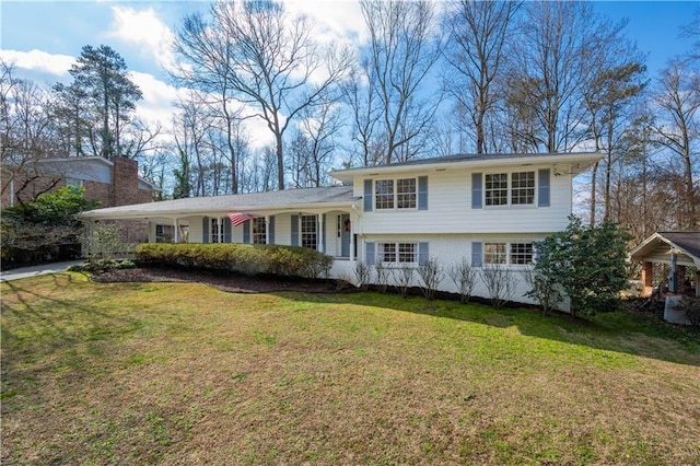 tri-level home featuring brick siding and a front yard