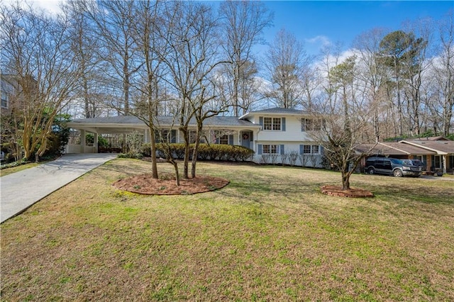 tri-level home featuring driveway, an attached carport, and a front lawn