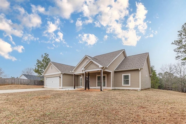 view of front of home with a porch, a garage, and a front lawn