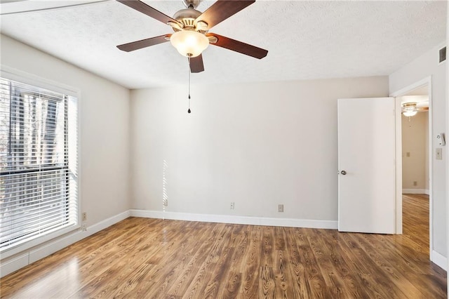 empty room with wood-type flooring and ceiling fan