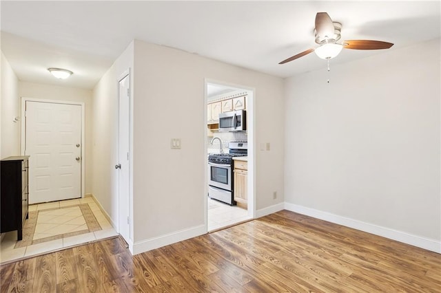 interior space with light hardwood / wood-style flooring and ceiling fan