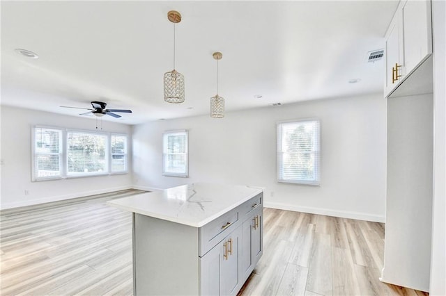 2502 Tupelo St SE, Atlanta, GA 30317 - kitchen with light wood-style floors, plenty of natural light, open floor plan, and gray cabinets