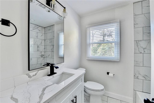 2502 Tupelo St SE, Atlanta, GA 30317 - full bathroom featuring vanity, toilet, and marble look tiles