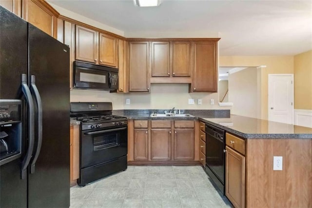 kitchen with kitchen peninsula, sink, and black appliances