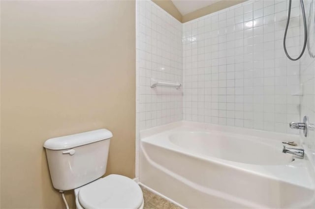 bathroom with tiled shower / bath combo and toilet