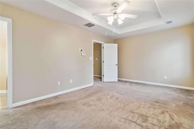 unfurnished room featuring carpet flooring, ceiling fan, and a tray ceiling