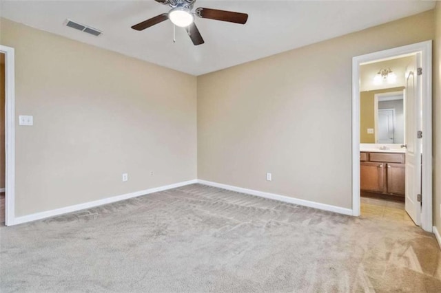 interior space featuring ceiling fan and light colored carpet