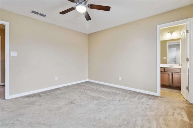 carpeted spare room with ceiling fan