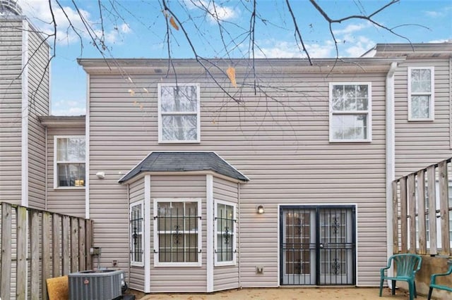 rear view of house with a patio and central AC unit