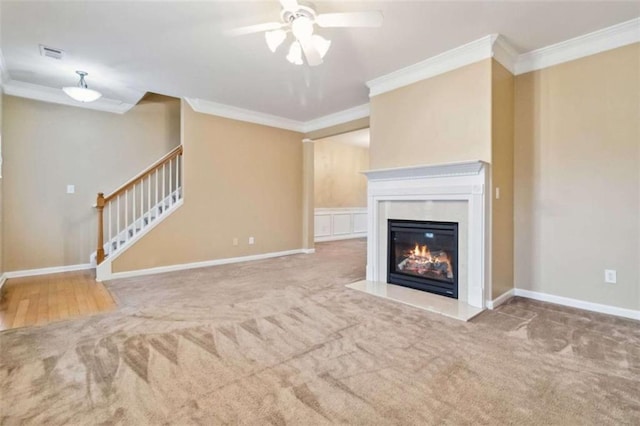 unfurnished living room with ceiling fan, carpet floors, and ornamental molding