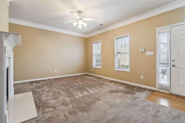 unfurnished living room with carpet, ceiling fan, and ornamental molding