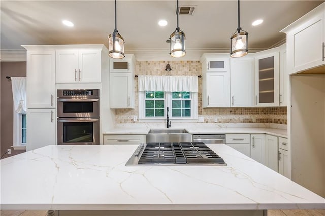 6065 Standard View Dr, Duluth, GA 30097 - kitchen featuring a sink, appliances with stainless steel finishes, crown molding, a kitchen island, and decorative backsplash