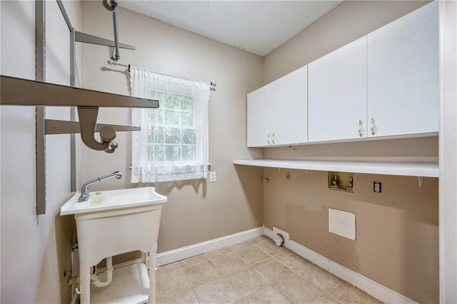 6065 Standard View Dr, Duluth, GA 30097 - washroom with washer hookup, baseboards, cabinet space, and light tile patterned flooring