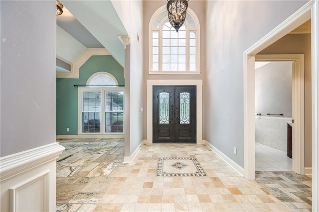 6065 Standard View Dr, Duluth, GA 30097 - entrance foyer featuring a towering ceiling, healthy amount of natural light, french doors, a chandelier, and baseboards