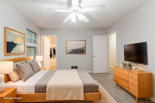5218 Tina Ct, Stone Mountain, GA 30083 - bedroom featuring light colored carpet, ceiling fan, baseboards, and a walk in closet