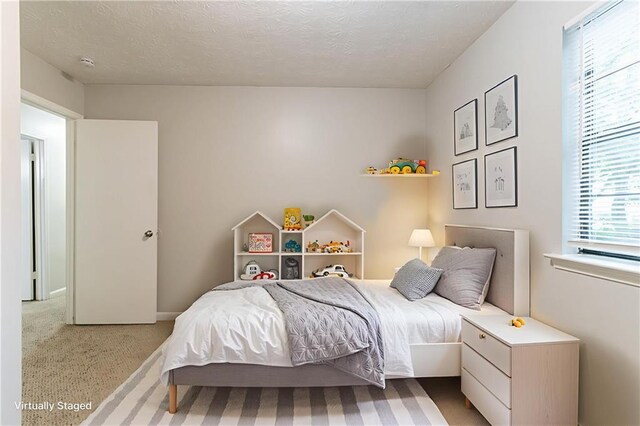 5218 Tina Ct, Stone Mountain, GA 30083 - carpeted bedroom with a textured ceiling