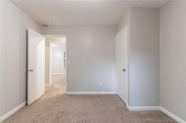 5218 Tina Ct, Stone Mountain, GA 30083 - spare room with light colored carpet, baseboards, a textured ceiling, and a smoke detector