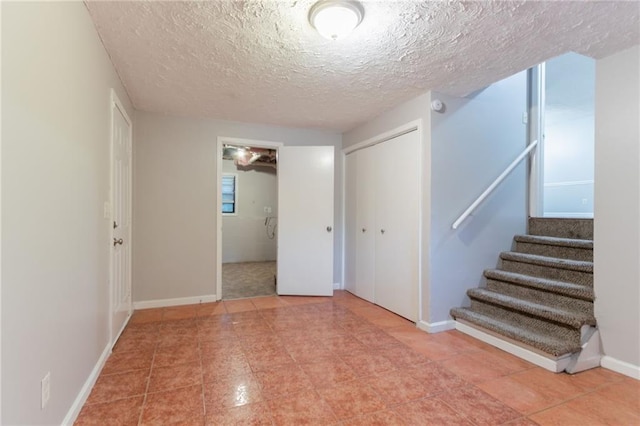 5218 Tina Ct, Stone Mountain, GA 30083 - spare room with stairway, a textured ceiling, and baseboards