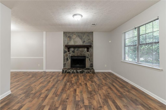 5218 Tina Ct, Stone Mountain, GA 30083 - unfurnished living room featuring wood finished floors, a textured ceiling, baseboards, and a fireplace