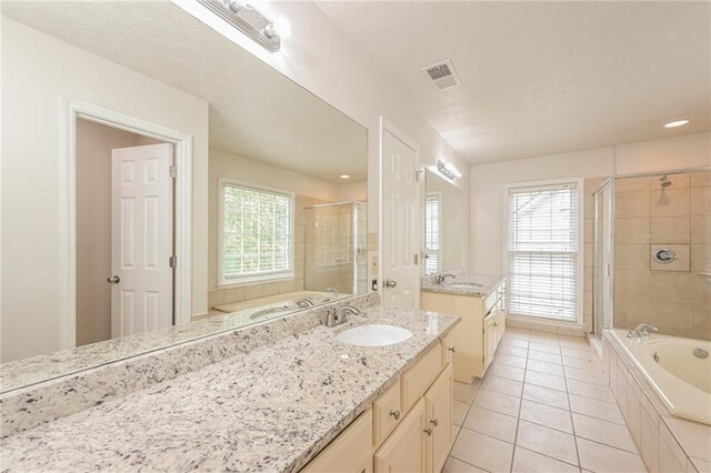 bathroom featuring vanity, tile patterned floors, a healthy amount of sunlight, and separate shower and tub