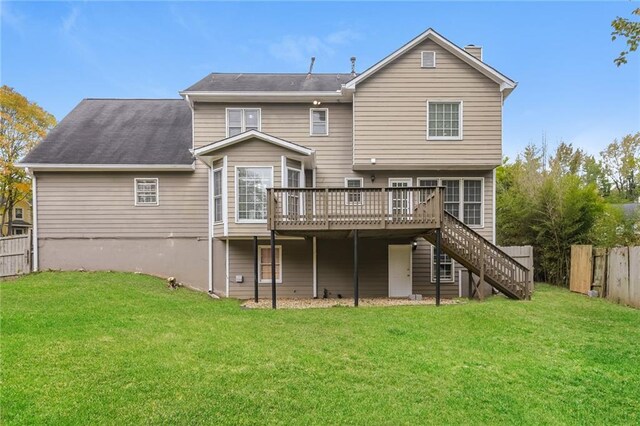back of property with a lawn and a wooden deck