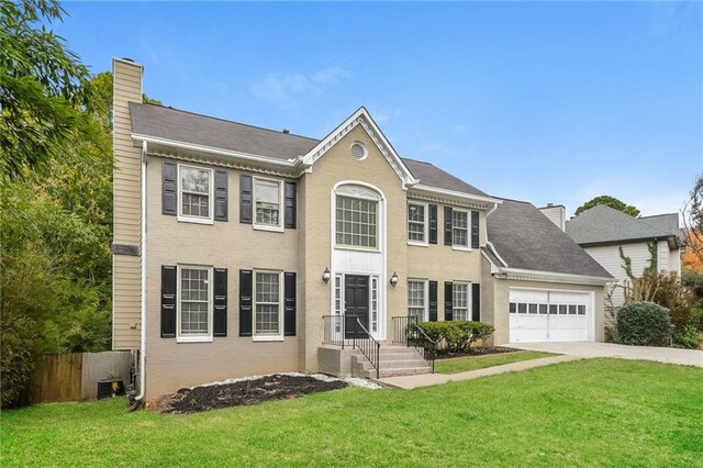 colonial-style house with a garage and a front yard