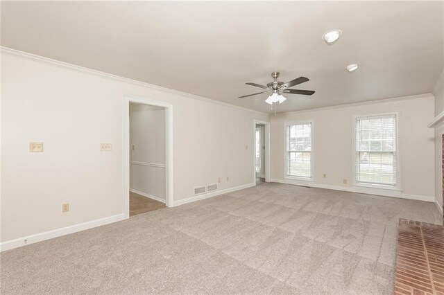 unfurnished room featuring light carpet, ceiling fan, and crown molding