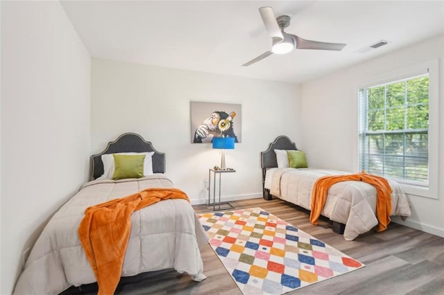 bedroom with ceiling fan and hardwood / wood-style flooring