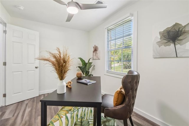 home office featuring wood-type flooring and ceiling fan