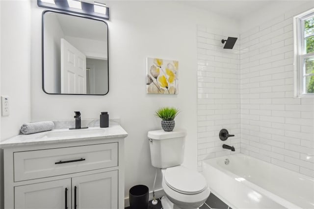 full bathroom with vanity, tiled shower / bath combo, and toilet