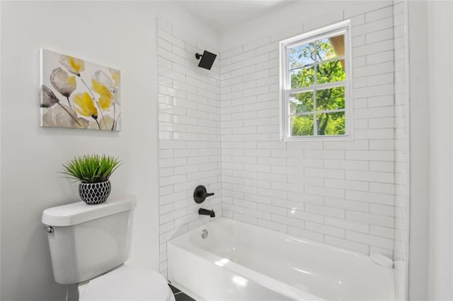 bathroom featuring tiled shower / bath and toilet