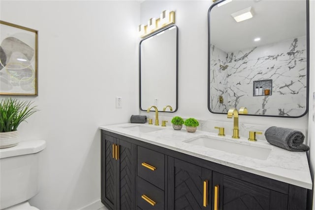 bathroom with toilet and double sink vanity