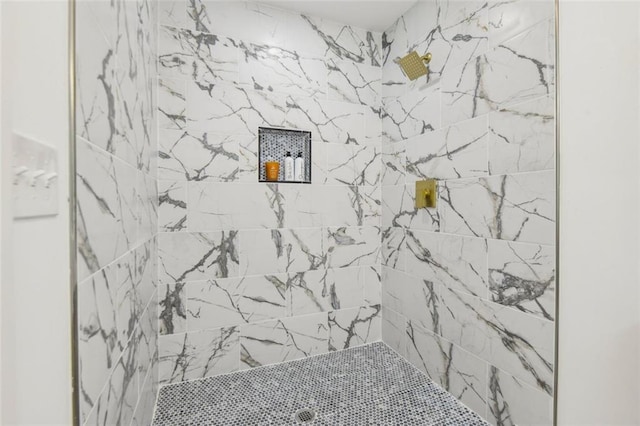 bathroom with a tile shower