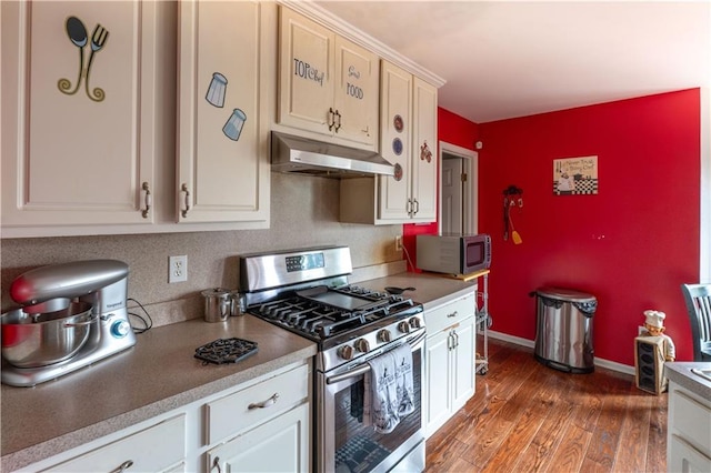 kitchen featuring appliances with stainless steel finishes, dark hardwood / wood-style floors, and white cabinets