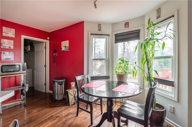 dining area with hardwood / wood-style flooring and washer / dryer