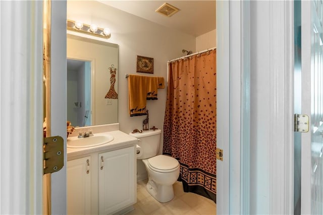 bathroom featuring tile patterned flooring, vanity, curtained shower, and toilet